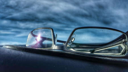 Glasses on car dashboardの素材