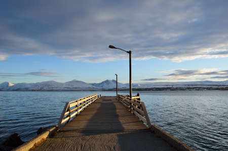 person enjoying sunset on wooden pierの写真素材