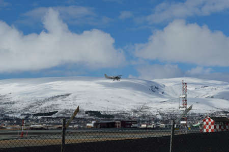 TROMSOE, NORWAY - APRIL 17, 2016: small school plane attempts to land on Langnes airport