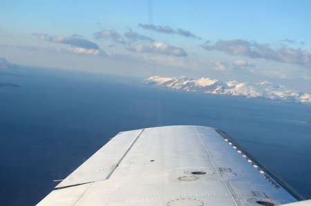 beautiful and majestic snowy mountain landscape with ocean in the background