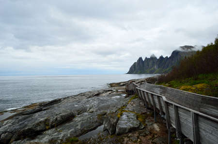 cool shaped wooden bridge leading down to the view point to see the Okshornan mountainの写真素材