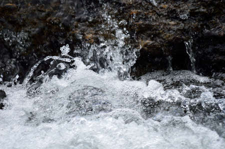 splashing water in riverの写真素材