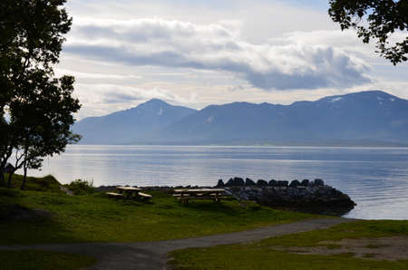 beautiful mountain and fjord landscape with wooden park benches in front