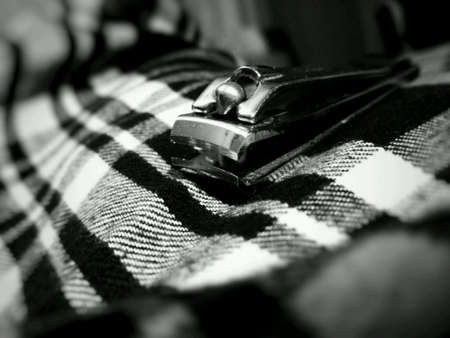 Nail clipper on man leg macro monochrome