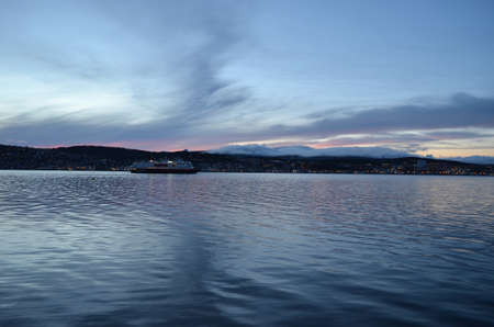 TROMSOE, NORWAY SEPTEMBER 29, 2016: The Norwegian coastal express, Hurtigruten, leaving Tromsoe city. The coastal express sails the lenght of Norway from south to north and north to southのeditorial素材