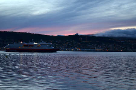 TROMSOE, NORWAY SEPTEMBER 29, 2016: The Norwegian coastal express, Hurtigruten, leaving Tromsoe city. The coastal express sails the lenght of Norway from south to north and north to southのeditorial素材