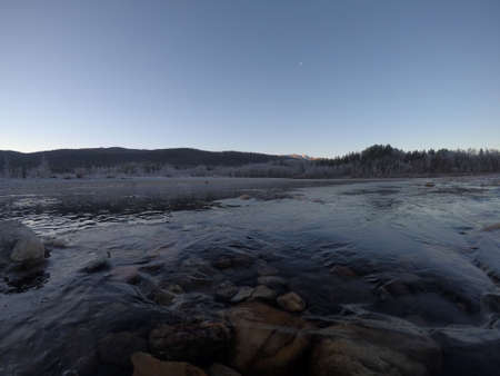 cold frozen river stream in late autumn