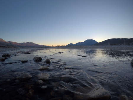 cold frozen river stream in late autumn