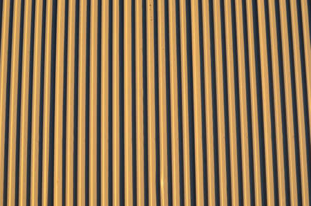 light brown corrigated steel plate building wall backgroundの写真素材