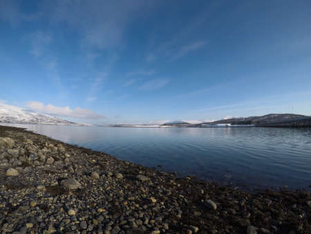old car bridge over blue fjord as the winter sun is risingの写真素材