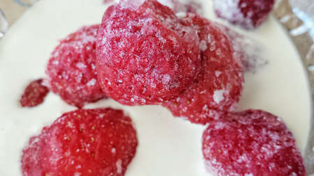 Sweet strawberries in cream with honey closeupの素材