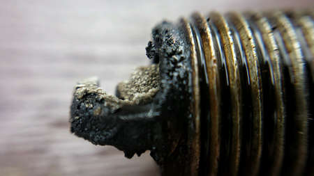 Old charred used car sparkplug macro photoの素材