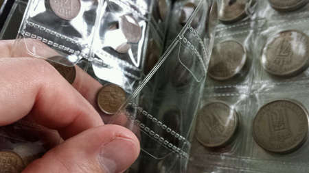 Turning pages in coin book with old norwegian coinsの素材
