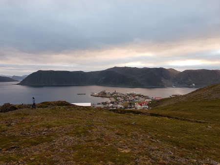 beautiful settlement of honningsvaag in northern norway at dusk with mountains and seaの写真素材