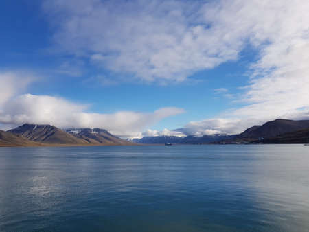 blue sea and mountain view with longyear city in the fjord on svalbard islandの写真素材