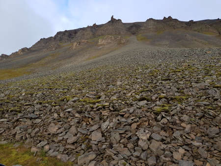 massive mountain with loose rock slide stone on svalbard, bear valleyの写真素材