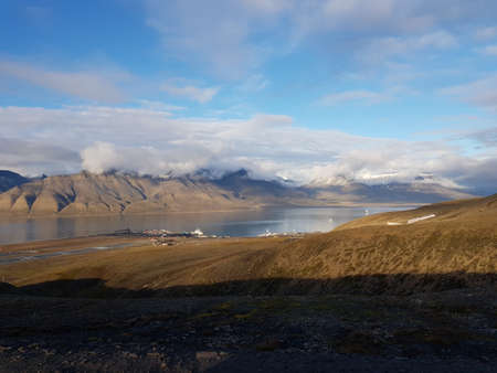 beautiful overview photo of parts of longyear city airport with mighty mountains and sea scapeの写真素材