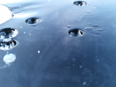Water drops on a blue background. Shallow depth of field.