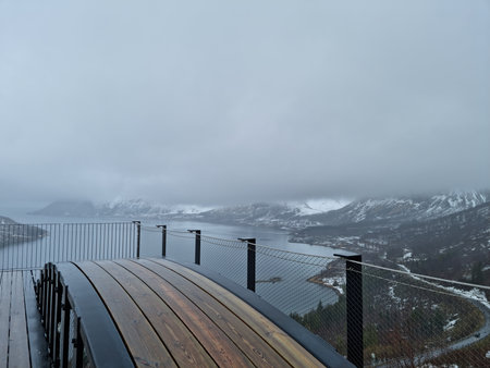 Wooden deck overlooking the fjord in Norway on a cloudy day