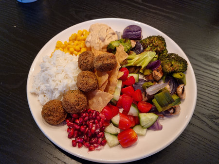 homemade vegetarian meatballs with different side dishes of vegetablesの写真素材