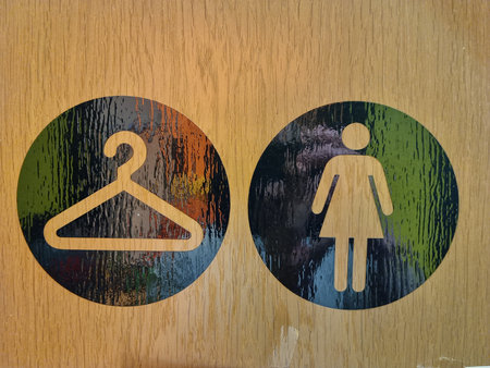 Male and female toilet signs on the wooden background.の写真素材