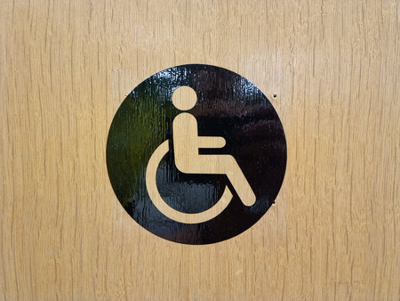 Disabled sign on the wooden door. Handicapped symbol.の写真素材