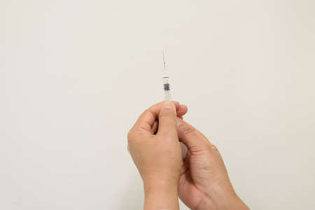 Close up doctor's hand holding syringe for vaccination.Vaccine for protection concept.の写真素材