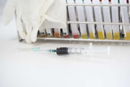 Syringe and blood test tube for coronavirus (COVID-19) on white background.Different blood test tube.Laboratory medical concept.の写真素材