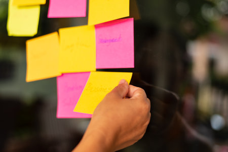 Sticky notes on the wall with blurred background, business concept.