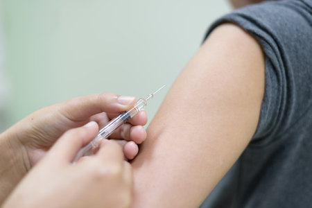 Doctor's hand injecting for vaccination into the arm woman patient.Vaccine for protection HPV (Human Papillomavirus) infection concept.の写真素材