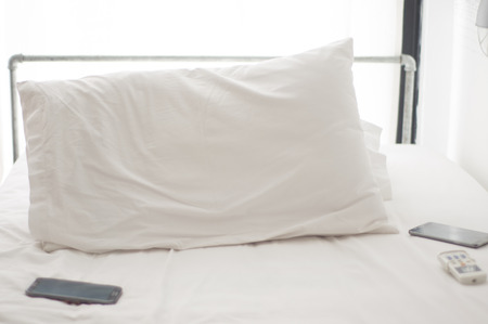 White pillows on a bed Comfortable soft pillows on the bedの写真素材