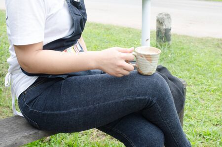 Women are drinking hot coffee in a coffee shop.の写真素材
