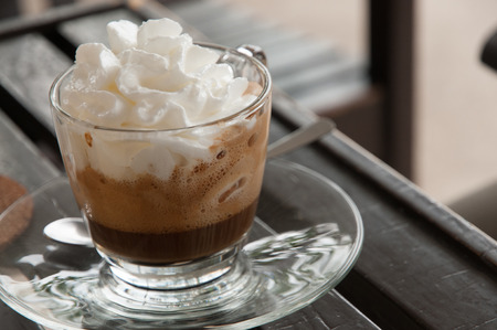 Viennese coffee in glass cup with whipped cream.の写真素材