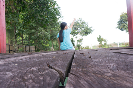 A young girl sitting by the poolの写真素材