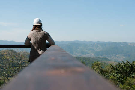 Beautiful young woman on the observation deck in Doi Wawee Chiangrai city Thailandの写真素材