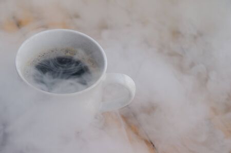 hot Coffee cup with steam on tebleの写真素材