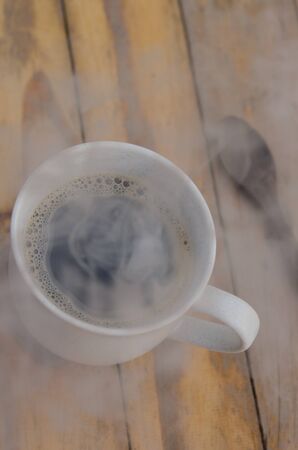 hot Coffee cup with steam on tebleの写真素材