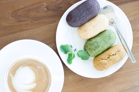 Delicious colourful eclairs with on a White plate