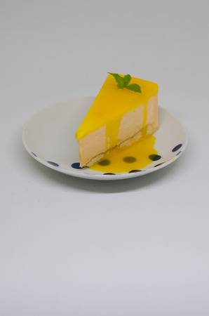 A piece of yellow mango cake with Mango jellyの写真素材