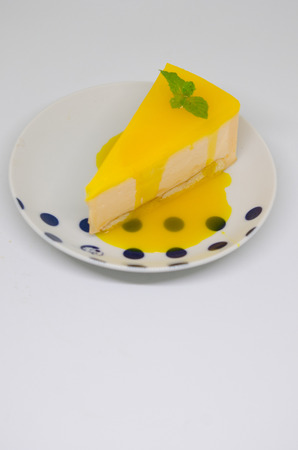 A piece of yellow mango cake with Mango jellyの写真素材