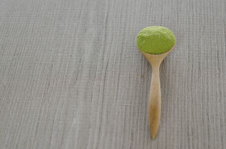 Wooden spoon with powdered matcha green teaの写真素材