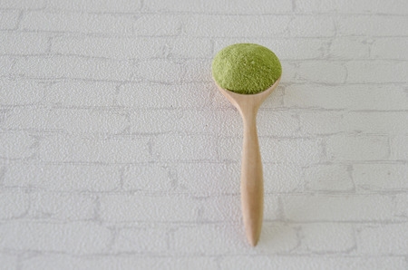 Wooden spoon with powdered matcha green teaの写真素材