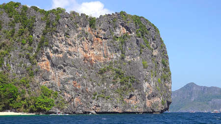 gorgeous view of the beach with big cliffs and blue skyの写真素材