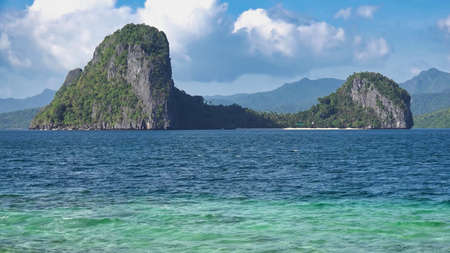 beautiful beach views and steep rock cliffs and blue skyの写真素材
