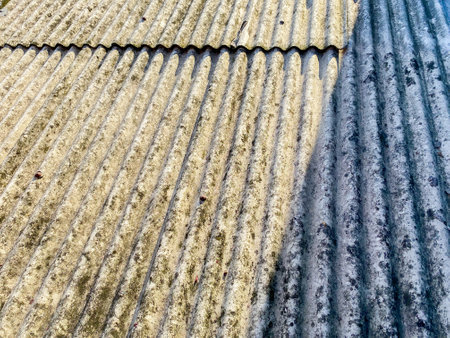 Portrait of an asbestos house roof during the day. Old house roof background.の写真素材
