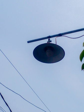 Street lights during the day. Street lights hung overhead.