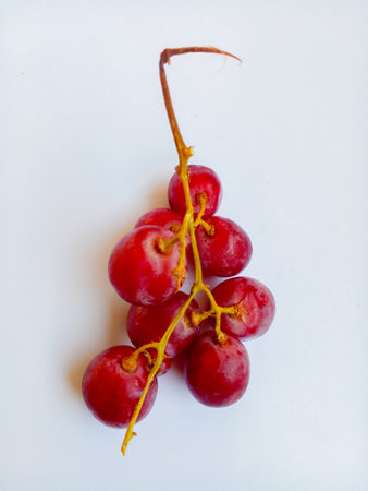 Fresh red grapes isolated on white background. Sweet and delicious grapes.の写真素材