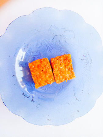 Fried tempeh isolated on white background. Delicious typical Indonesian food.の写真素材