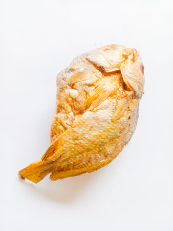 Fried salted fish isolated on white background. A side dish with a salty taste, but delicious to eat.の写真素材