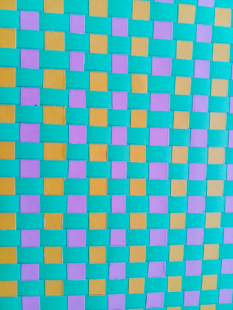 Woven paper with beautiful patterns. Woven paper is green, orange and pink.の写真素材